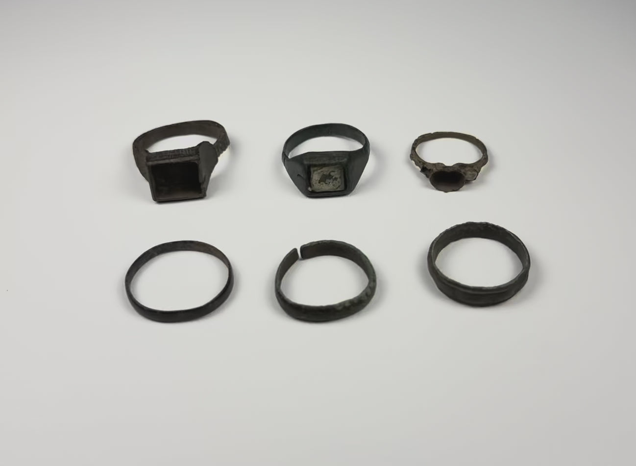 Video showing a group of six Late Roman to Early Byzantine bronze finger rings from multiple angles, circa 3rd–7th century CE