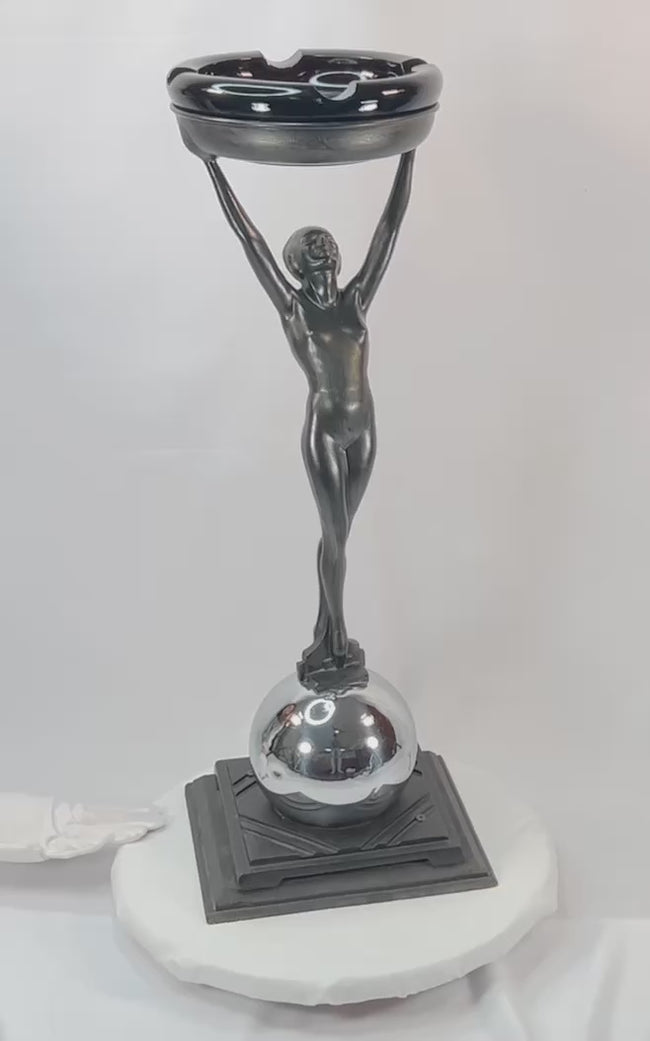 Rare Art Deco smoking stand, circa 1925–1935, attributed to Frankart Inc. New York. Features nude female figure with raised arms supporting circular tray, original patinated finish, and stepped Deco base. Iconic Jazz Age decorative design.