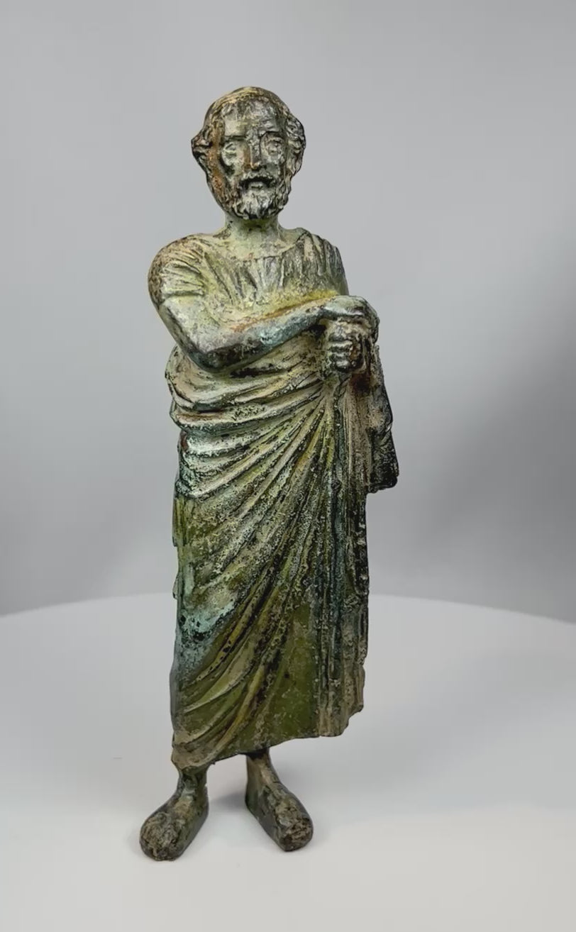 360° rotating view of a 19th century Grand Tour bronze classical male figure sculpture with toga, detailed drapery, and aged green patina