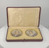 360-degree rotating view of a matched pair of late Victorian to Edwardian colour portrait miniatures, circa 1880–1910 CE, depicting a formally dressed gentleman and woman. Both oval portraits feature gilt-coloured metal surrounds and are displayed in a burgundy leather-covered presentation case with cream velvet mounting, satin lining, and folding easel support. Formerly part of the historic Sears family collection from the estate of Joseph W. Haley, Pride's Crossing, Massachusetts, USA.