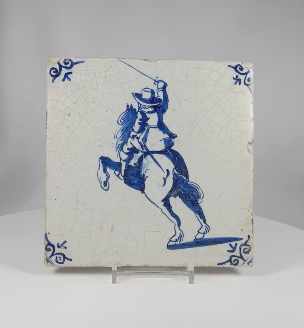 360 degree view of an antique Dutch Delft blue and white tile depicting a mounted rider raising a sword on a rearing horse.