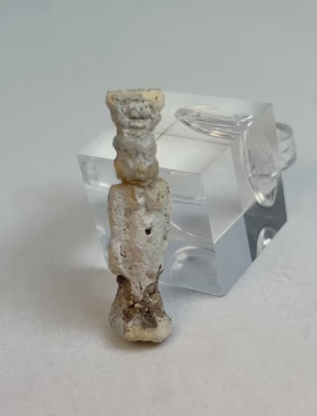 Rotating video of an ancient Egyptian faience amulet figure with heavy burial patina.