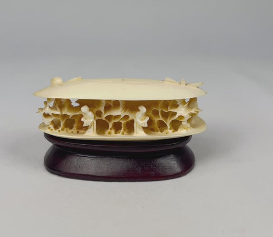 360-degree video rotation of a Chinese carved bone clam shell miniature showing the hollow interior scene and carved figures.