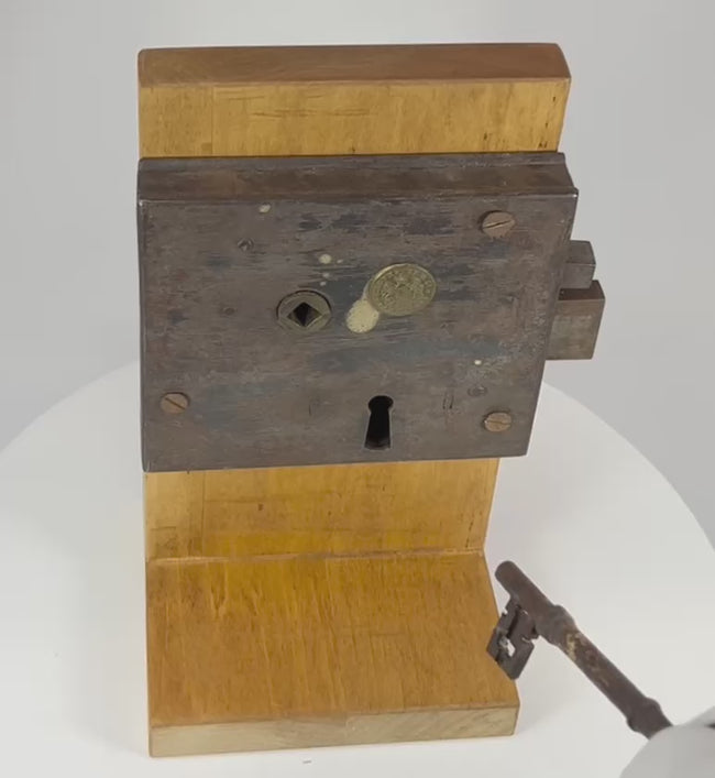 Demonstration of antique rim lock as key is turned, engaging sliding bolt mechanism and internal components