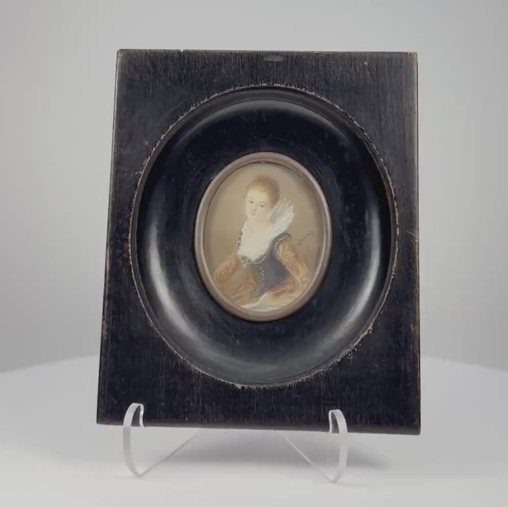 Video showcasing an antique Continental European miniature portrait of a young woman dating to circa 1860–1890, highlighting her jeweled blue bodice, amber sleeves, delicate lace ruff, fine watercolor and gouache detailing, ebonized wooden frame, brass bezel, and historic reverse label.