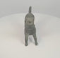 360-degree rotating view of a possibly ancient Roman bronze barking dog figurine, featuring an open mouth, raised head, decorative collar, extended legs, and distinctive curled tail. The sculpture displays dark green patination, surface wear, and a visible opening in the rear flank.