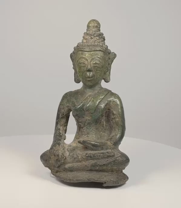 360-degree video of an antique Lan Na bronze Shakyamuni Buddha showing the earth-touching gesture, aged patina, sculpted hair, base, and open underside