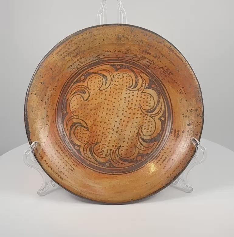 Rotating view of Pre-Columbian Greater Nicoya painted ceramic plate showing geometric interior decoration and striped underside