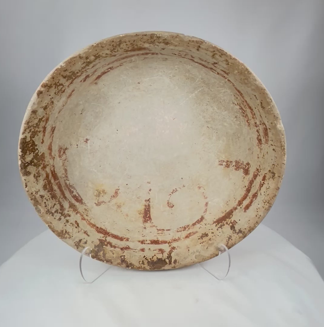 Rotating view of a Pre-Columbian terracotta bowl with shallow wide form, faint red-ochre decoration, and natural archaeological patina, circa 300 BCE–900 CE.
