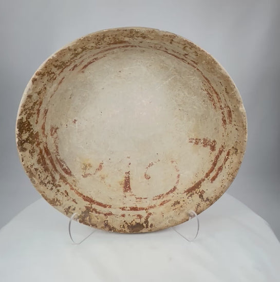 Rotating view of a Pre-Columbian terracotta bowl with shallow wide form, faint red-ochre decoration, and natural archaeological patina, circa 300 BCE–900 CE.