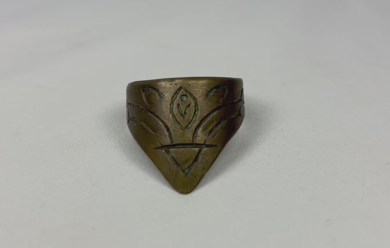 360-degree rotating video view of a brass archer’s thumb ring with engraved motif.