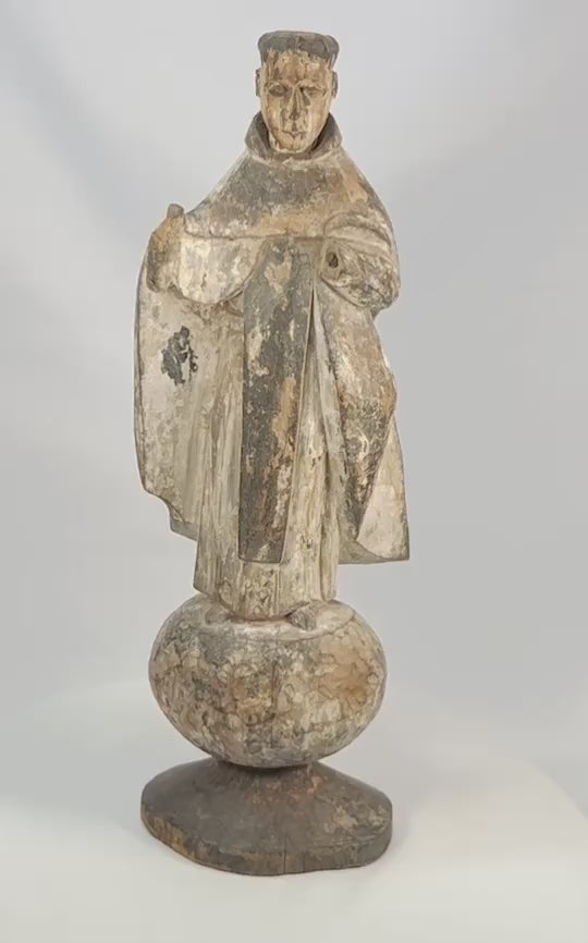 Antique Spanish Colonial santo figure from Latin America (Mexico or Peru), 17th–18th century, carved wood with remnants of polychrome and gesso, depicting a friar or monk in a robe, mounted on an integral rounded base, photographed on a white background.