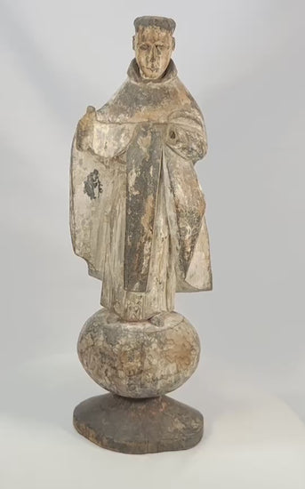 Antique Spanish Colonial santo figure from Latin America (Mexico or Peru), 17th–18th century, carved wood with remnants of polychrome and gesso, depicting a friar or monk in a robe, mounted on an integral rounded base, photographed on a white background.