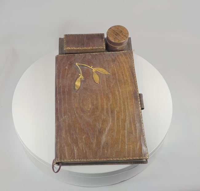 Rotating video of antique leather writing slope showing gilt details, inkwell compartment, and interior storage