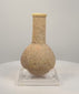 360-degree rotating view of an attributed Roman Imperial stone unguentarium, circa 1st–3rd century CE, featuring a rounded bulbous body, elongated cylindrical neck, thick flared rim, and weathered beige stone surface. The video highlights the vessel’s distinctive shape and porous texture.