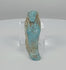 360-degree rotating view of an Ancient Egyptian turquoise-blue faience ushabti funerary figure, attributed to the Late Period–Ptolemaic Period (664–30 BCE), showing its mummiform body, crossed arms, stylized facial features, projecting foot base, and weathered blue glaze with earthy-brown deposits.