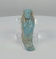 360-degree rotating view of an Ancient Egyptian turquoise-blue faience ushabti funerary figure, attributed to the Late Period–Ptolemaic Period (664–30 BCE), showing its mummiform body, crossed arms, stylized facial features, projecting foot base, and weathered blue glaze with earthy-brown deposits.