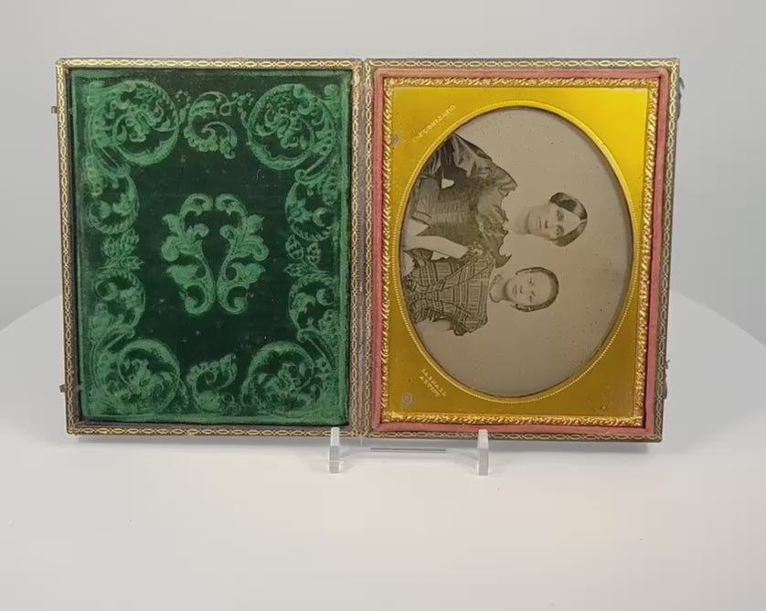 Video showcasing a mid-19th-century cased ambrotype of a woman and child with gilt-brass mat, green velvet lining, handwritten family label, and embossed case