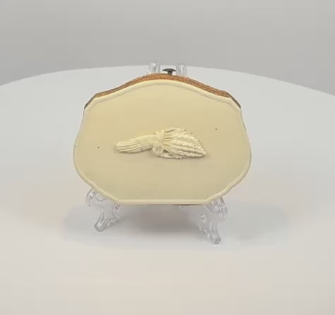 Video showcasing a Victorian carved bovine bone coin purse with hand holding wheat motif, expandable leather sides, purple silk compartments, and metal clasp, circa 1870–1900