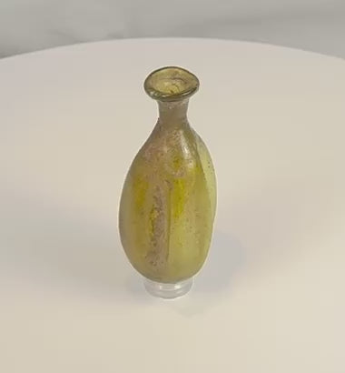 360-degree view of an ancient Roman free-blown olive green glass flask, circa 1st–3rd Century AD, showcasing its vertically fluted body, flared rim, archaeological weathering, mineral deposits, and authentic Roman glassmaking craftsmanship.