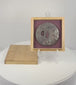 Rotating view of an antique Japanese iron tsuba with mixed-metal sage and spider decoration, displayed in its purple-lined wooden box