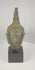 360-degree rotating video of a Sukhothai bronze Buddha head with flame finial and natural patina, circa 14th–15th century CE