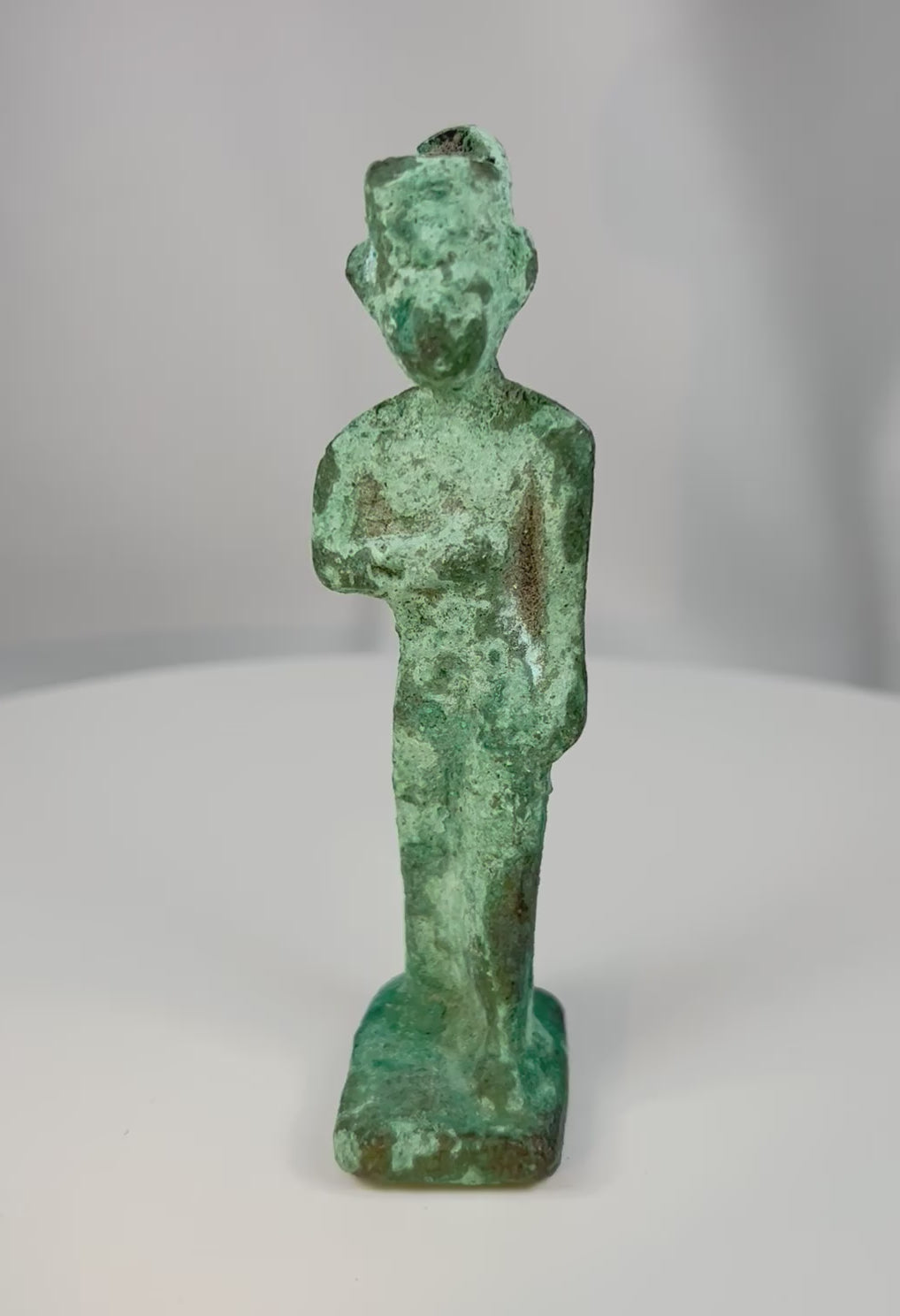 360-degree view of an ancient Egyptian bronze votive statuette of a standing female deity, likely Neith, from the Late Period to Ptolemaic era, showing sculptural details and aged green patina.