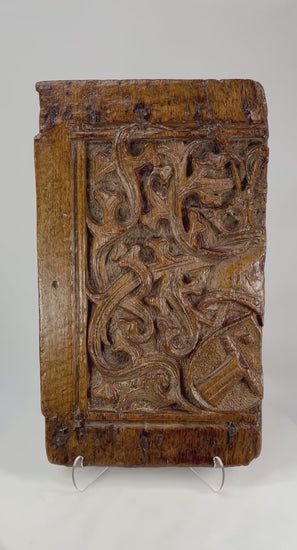 360° rotation video of 16th-century Gothic oak panel displaying deep relief carvings, heraldic shield, and aged patina from all viewing angles.