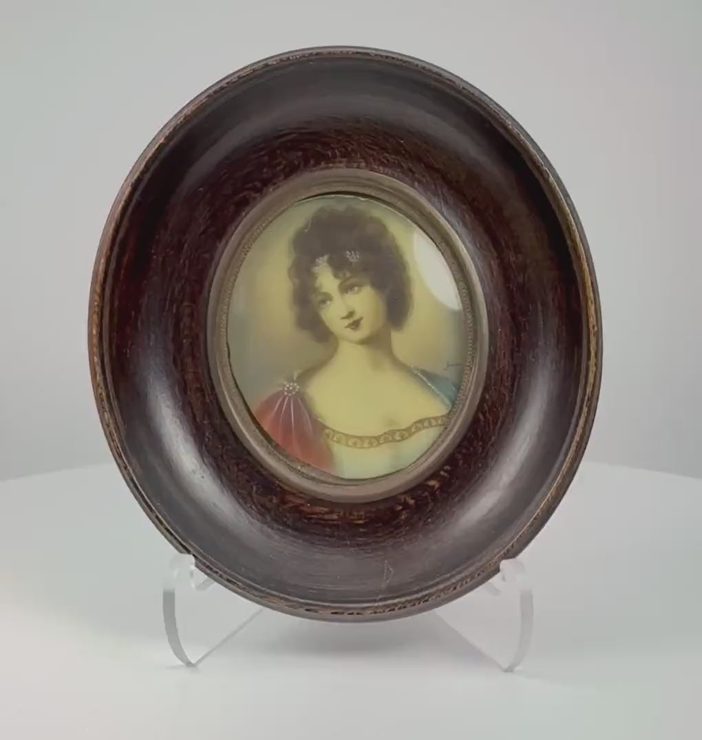 Video showcasing an antique French miniature portrait of Madame Juliette Récamier, dating to circa 1890–1910, highlighting the delicate watercolor and gouache painting, Empire-style gown, convex glass, brass oval bezel, ebonized wooden frame, and historic identification label.