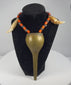 Video showing an antique Konyak Naga warrior necklace with brass pendant, glass trade beads and paired animal teeth