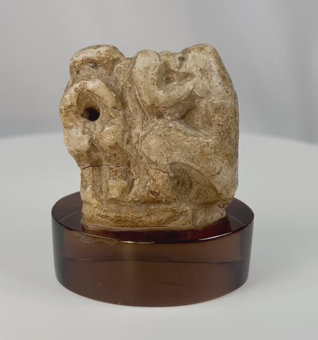 Ancient Egyptian limestone baboon fragment representing Thoth in stylized form.