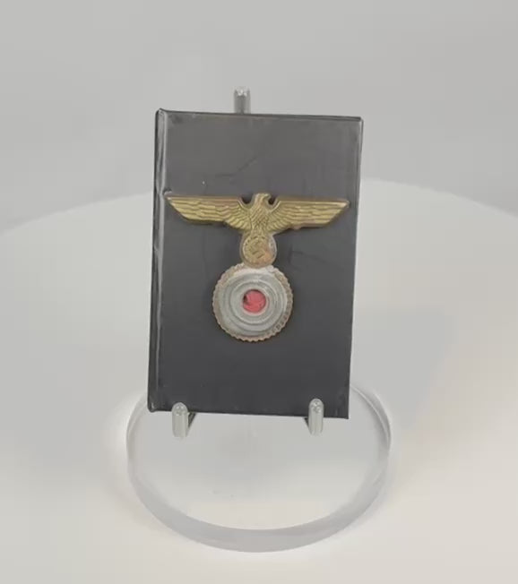 Video displaying a WWII German Kriegsmarine gilt eagle and cockade cap insignia from multiple angles