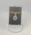Video displaying a WWII German Kriegsmarine gilt eagle and cockade cap insignia from multiple angles