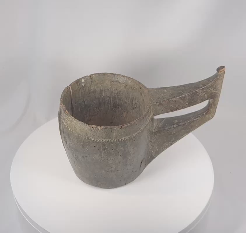 360-degree view of an antique Himalayan hand-carved wooden ceremonial vessel featuring an elongated handle, carved triangular border motifs, rich aged patina, and ethnographic tribal character