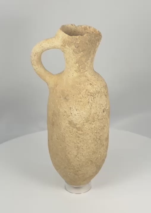 360-degree video of an authentic Roman Provincial terracotta pouring vessel showcasing its globular body, flared pouring rim, loop handle, archaeological patina, and ancient Mediterranean craftsmanship.