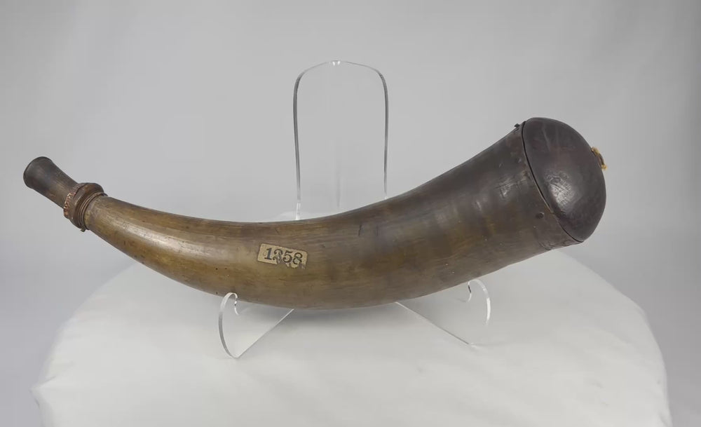 Rotating view of an 18th–early 19th century historic powder horn made from natural animal horn with wooden stopper, fitted base, and original inventory markings.