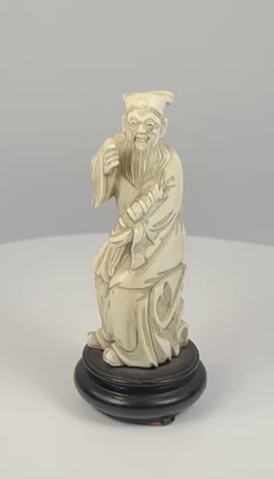 360-degree video of an antique Chinese Zhang Guolao Eight Immortals figure with a fish drum and ebonized wooden base