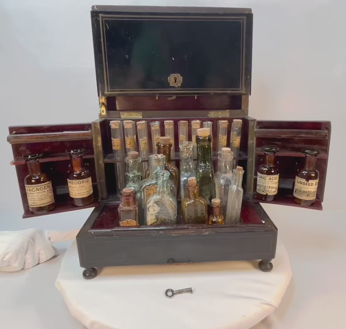 180-degree view of Victorian traveling apothecary cabinet with original antique medicine bottles and contents