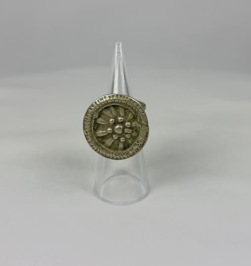 Late 19th century European silver-toned ring with raised rosette floral motif, beaded border, and tapered band, antique Victorian-era jewelry piece
