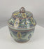 360-degree rotating view of an antique Moroccan hand-painted covered pottery jar from Fes, featuring vibrant polychrome floral decoration, a fitted domed lid, glazed earthenware construction, and traditional Islamic-inspired ornamentation.
