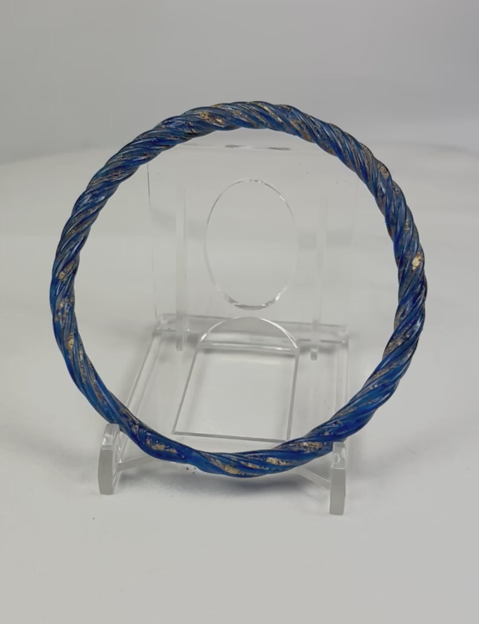 Rotating view of ancient Roman cobalt-blue glass bracelet showing circular form and shimmering iridescence.