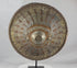 Rotating view of a late 19th-century Ethiopian Ras shield with a convex hide body, golden-brown velvet covering, pierced and engraved silvered and gilt metal mounts, radiating bosses, a large central sunburst boss, red leather reverse, and original padded handgrip