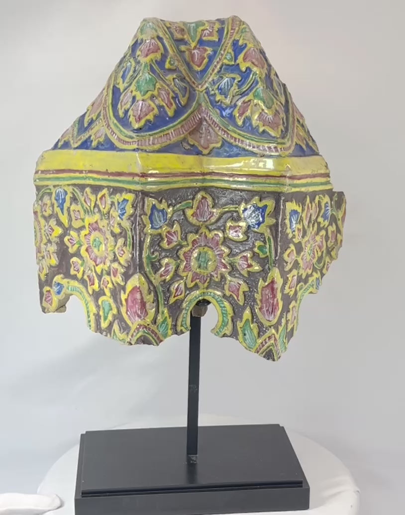 360-degree video of an 18th-century Rattanakosin polychrome ceramic corner tile with ornate floral motifs on display stand.