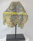 360-degree video of an 18th-century Rattanakosin polychrome ceramic corner tile with ornate floral motifs on display stand.