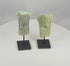 Video of two ancient Dong Son bronze socketed axe heads with flaring blades, hafting apertures, and archaeological patina