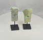 Video of two ancient Dong Son bronze socketed axe heads with flaring blades, hafting apertures, and archaeological patina