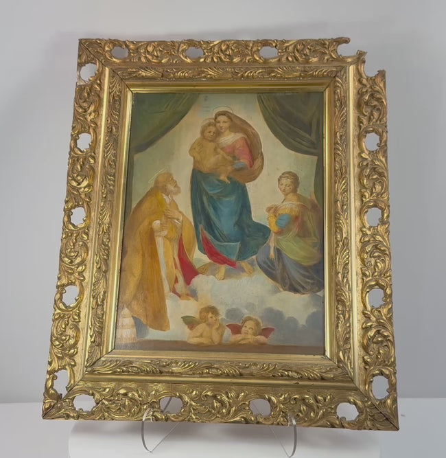 Early 20th-century German Sistine Madonna reproduction shown in its ornate gilt frame, highlighting Raphael’s composition, decorative Rococo Revival carving and historic reverse labels.