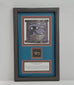 Video of a framed ancient Egyptian Eye of Horus (Wedjat) soapstone amulet attributed to the Late Period, circa 663–304 BCE. The display features an ornate black frame, deep blue background, Egyptian Eye of Horus illustration, and historical identification plaque, with close-up views of the carved stone amulet and its aged surface details.