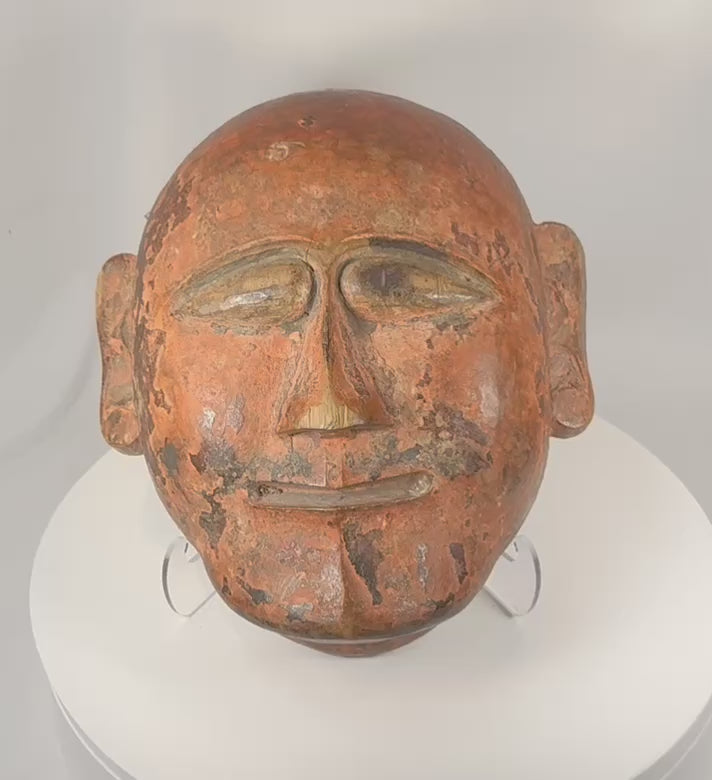 360-degree view of a hand-carved African tribal ceremonial mask featuring stylized facial features, remnants of original pigment, aged patina, and strong ethnographic character.