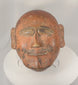 360-degree view of a hand-carved African tribal ceremonial mask featuring stylized facial features, remnants of original pigment, aged patina, and strong ethnographic character.